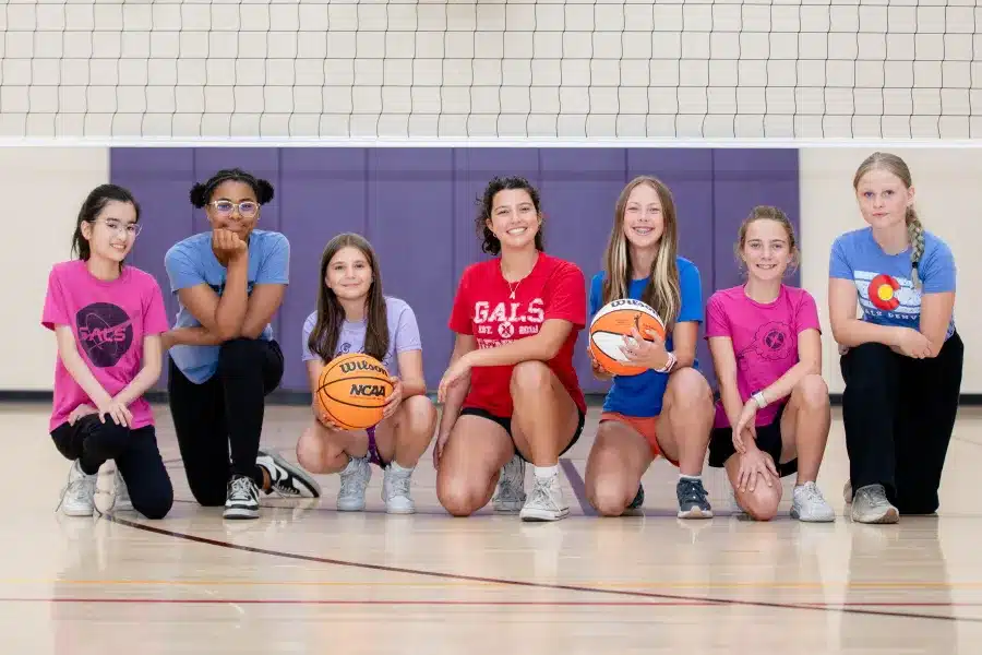 Grgup of GALS students in the gym holding basketballs